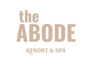 The Abode Resort & Spa logo with a simple and sophisticated beige design